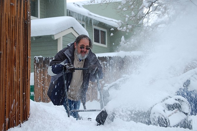 Brian Duggan/Nevada AppealDanny Morrison, 57, pushes a snow blower through a friend&#039;s driveway after a storm dumped more than a foot of snow in Carson City on Monday.