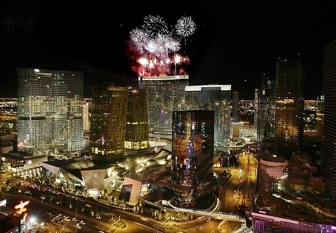 Fireworks shoot off of the roof of the Aria Hotel and Casino moments before its opening at CityCenter in Las Vegas on Wednesday, Dec. 16, 2009. (AP Photo/Laura Rauch)