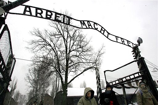 FILE - In this Jan. 26, 2005 file photo visitors walk through the entrance gate of the Auschwitz Nazi concentration camp in Oswiecim, southern Poland, a day before the commemorations of the 60th anniversary of the liberation of the Auschwitz Nazi concentration camp by Soviet troops.  Polish police say the infamous iron sign over the gate to the Auschwitz memorial site with the cynical phrase &quot;Arbeit Macht Frei&quot; _ German for &quot;Work Sets You Free&quot; _ has been stolen. Police spokeswoman Katarzyna Padlo said police believe it was stolen between 3:30 a.m. and 5 a.m. Friday, Dec. 18, 2009, when museum guards noticed that it was missing and alerted police.  (AP Photo/Herbert Knosowski, File)