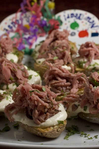 This photo taken Dec. 6, 2009 shows some finger food. These easy to make new potatoes with roast beef and horseradish cream cost half what frozen hors d&#039;oeuvres do and serve nicely with a variety of sliced meat toppings. (AP Photo/Larry Crowe)