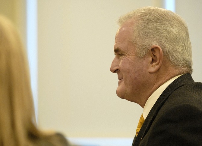 Gov. Jim Gibbons gets a smile on his face just before answering whether he thought the settlement in his divorce case was equitable during a court hearing in Reno, Nev., Monday Dec. 28, 2009 regarding his divorce from Dawn Gibbons.   After the smile he told the judge he did think it was fair. (AP Photo/Marilyn Newton, The Gazette-Journal)