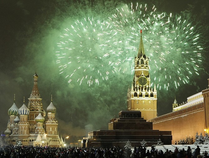 Russians celebrate the New Year on Red Square in Moscow, with the Kremlin in the background, right, and St. Basil&#039;s cathedral in background left, Friday, Jan. 1, 2010. Tens of thousands of people gathered on the Square to celebrate the new year, and view the fireworks as the clock on the Kremlin&#039;s Spassky Tower, right, struck midnight. (AP Photo/Mikhail Metzel)