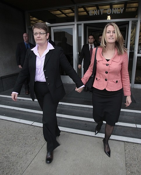Same-sex couple Kris Perry, left, and Sandy Stier hold hands outside of the federal courthouse after their first day in court in San Francisco, Monday, Jan. 11, 2010. A federal trial beginning on Monday in San Francisco will consider whether the Proposition 8 same-sex marriage ban in California is legal. (AP Photo/Marcio Jose Sanchez)