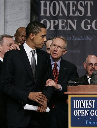 FILE - In this Jan. 18, 2006, file photo Senate Democratic Leader Harry Reid of Nev., center, joined by Sen. Barack Obama, D-Ill., left, prepares to outline the Democrat agenda for reform in the wake of the scandal involving former lobbyist Jack Abramoff, at the Library of Congress in Washington.  Reid apologized Saturday, Jan. 9, 2010, to President Barack Obama  for comments he made about Obama&#039;s race during the 2008 presidential bid, which are quoted in a yet-to-be-released book about the campaign titled &quot;Game Change&quot;. (AP Photo/J. Scott Applewhite, File)
