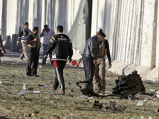 Iraqi police secure the site of a car bomb attack in Baghdad, Iraq, Monday, Jan. 25, 2010. Three parked car bombs struck near three Baghdad hotels popular with Western journalists and businessmen. (AP Photo/Karim Kadim)