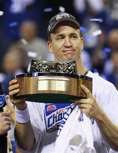 Indianapolis Colts quarterback Peyton Manning (18) holds the Lamar Hunt Trophy after the Colts&#039; 30-17 win over the New York Jets in the AFC Championship NFL football game Sunday, Jan 24, 2010, in Indianapolis.The Colts advance to the Super Bowl. (AP Photo/Darron Cummings)