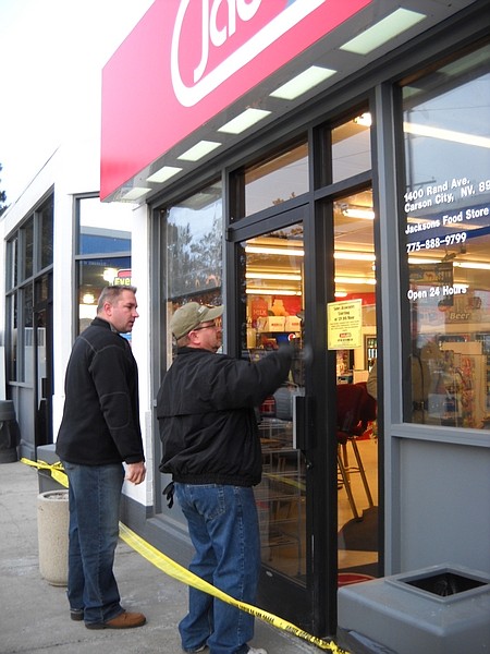 F.T. NortonAs Detective Dave Le Gros looks on, Carson City Sheriff&#039;s Forensic Specialist Dean Higman dusts for fingerprints on the front door of the Jacksons gas station after a robbery early Sunday morning.