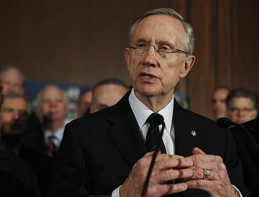 Senate Majority Leader Sen. Harry Reid of Nev., accompanied by Senate Democrats, gestures during a health care news conference on Capitol Hill in Washington, Wednesday, Dec. 23, 2009.   (AP Photo/Manuel Balce Ceneta)