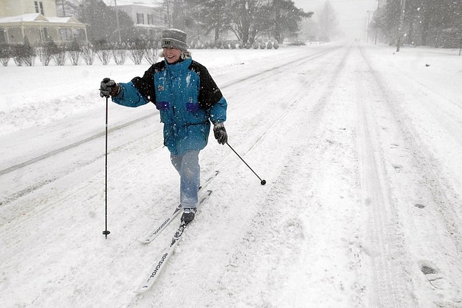 Liz Taylor skiis down Market Street in Onancock, Va. during a heavy snow storm on the Eastern Shore of Virginia on Saturday, Jan. 30, 2010. (AP Photo/Salisbury Daily Times, Jay Diem)