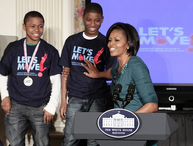 First lady Michelle Obama points out some student athletes as she announces a campaign to combat the rapidly growing problem of childhood obesity, Tuesday, Feb. 9, 2010, in the State Dining Room of the White House in Washington. (AP Photo/J. Scott Applewhite)