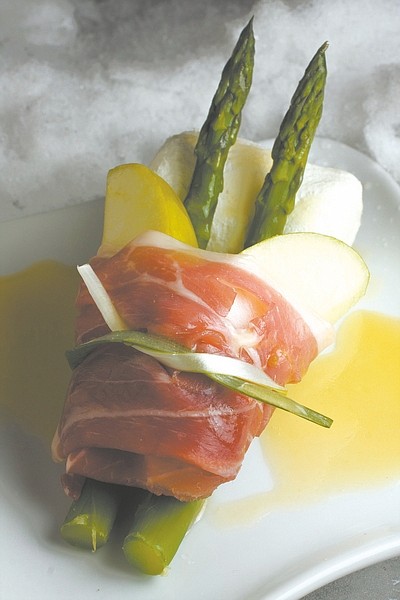 This photo taken Jan. 10. 2010 shows an arranged asparagus and apple salad with prosciutto and goat cheese sporting a pair of skis in a nod to alpine skiing. (AP Photo/Larry Crowe)