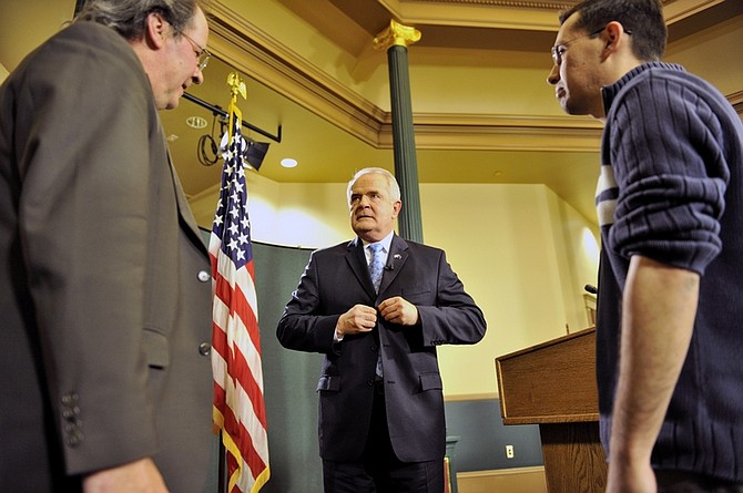 Gov. Jim Gibbons, center, stands with Dan Burns, his communications director, left, and a camera operator for the state as he prepares to give his state of the state speech upstairs in the Capitol building in Carson City, Nev. on Monday, Feb. 8, 2010. (AP Photo/Pool, Scott Sady)