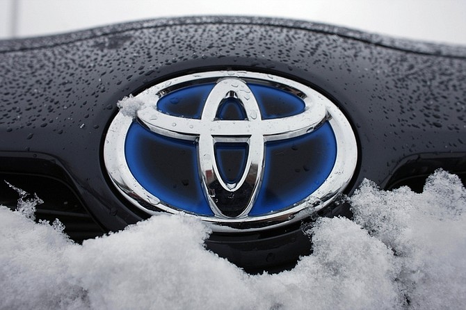 The Toyota logo is seen on a snow-covered 2010 Prius sedan at a dealership in Lakewood, Colo., Sunday, Feb. 7, 2010. Toyota plans to recall about 300,000 Prius hybrids worldwide over a brake problem and is likely to notify both the U.S. and Japanese governments Tuesday, news reports said, as a top executive will testify before U.S. lawmakers about defects that have tarnished its reputation for quality and safety. (AP Photo/David Zalubowski)