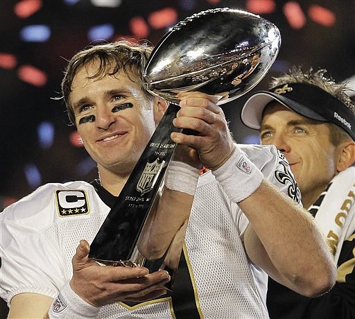 New Orleans Saints quarterback Drew Brees (9) celebrates with the Vince Lombardi Trophy after the Saints&#039; 31-17 win over the Indianapolis Colts in the NFL Super Bowl XLIV football game in Miami, Sunday, Feb. 7, 2010. (AP Photo/Julie Jacobson)