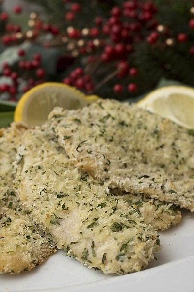 This photo taken Nov. 22, 2009 shows tilapia fillets. Bring a piece of the Italian tradition of serving fish on Christmas Eve with this fresh herb and panko-crusted tilapia fillets. Oven-frying results in a nice crunchy coating without the oil of pan-frying. (AP Photo/Larry Crowe)