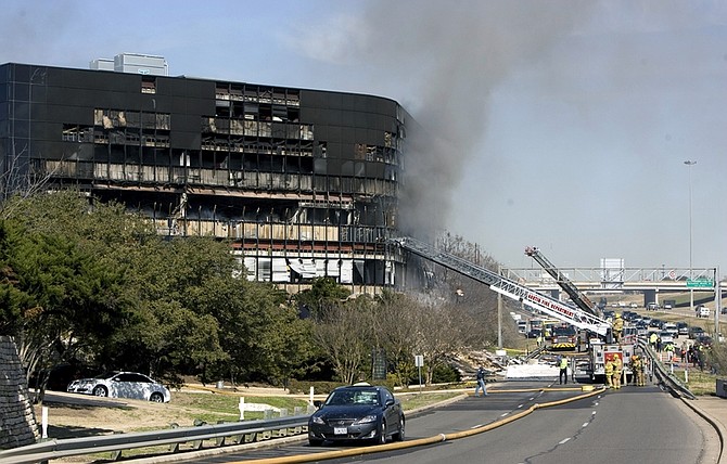 Smoke billows from a seven-story building after a small private plane crashed into the building  in Austin, Texas on Thursday Feb. 18, 2010. (AP Photo/Austin American-Statesman, Jay Janner/) MANDATORY CREDIT. NO MAGS, NO SALES, NO TV