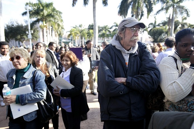 In this photo made Tuesday, Jan. 12, 2010, hundreds of people wait to enter a job fair in Hallandale Beach, Fla., to apply for the 600 retail and cafe jobs in the new shopping project, The Village at Gulfstream Park. Hundreds were turned away. The number of newly-laid off workers seeking jobless benefits rose more than expected last week, as the job market recovery proceeds slowly and unevenly. (AP Photo/J Pat Carter)