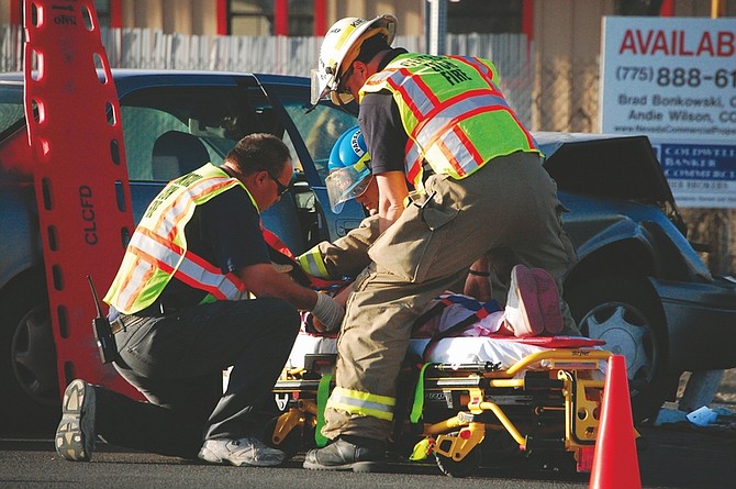 Brian Duggan/Nevada AppealLyon County first responders tend to one of the occupants of a car involved in a two-car collision on Monday afternoon. All five people involved, including two children, sustained minor injuries, according to the Nevada Highway Patrol.
