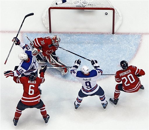 USA&#039;s Jamie Langenbrunner (15) celebrates a goal past Canada goalie Martin Brodeur (30) during the third period of a preliminary round men&#039;s ice hockey game at the Vancouver 2010 Olympics in Vancouver, British Columbia, Sunday, Feb. 21, 2010. (AP Photo/Matt Slocum)