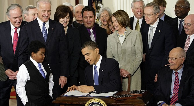 President Barack Obama signs the health care bill in the East Room of the White House in Washington, Tuesday, March 23, 2010. (AP Photo/J. Scott Applewhite)