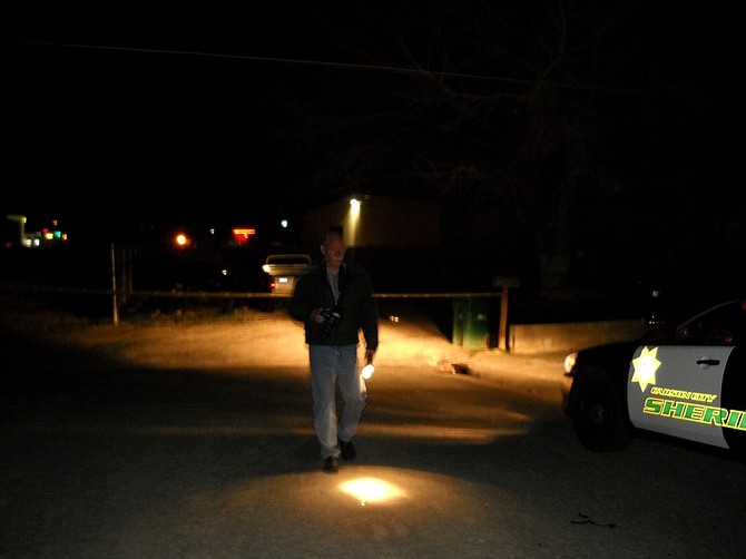 Crime scene technician Kurt Urbanski walks away from a home on Champion Street at which a man had been shot late Sunday night.