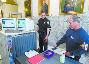 Capitol Police Officer Chris Klein runs FedEx worker Jesse Rivera through a security checkpoint at the Capitol in 2010. Security measures were increased after governors in all 50 states received threatening letters.