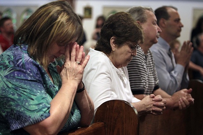 People participate in a prayer service at St. Joseph Catholic Church, Tuesday, April 6, 2010, in Whitesville, W.Va. The blast Monday at Massey&#039;s Upper Big Branch mine _ the nation&#039;s deadliest mining disaster since at least 1984 _ was believed to have been caused by a buildup of highly combustible methane . (AP Photo/Mark Humphrey)