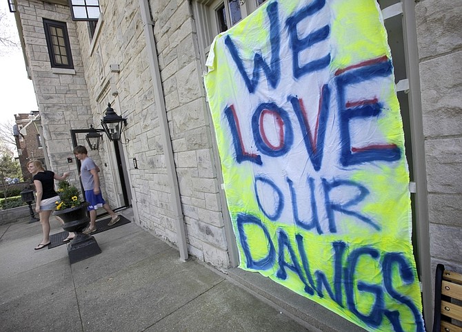 Students leaves the Kappa Alpha Theta sorority house on the the campus of Butler University in Indianapolis on Sunday, April 4, 2010. Signs have gone up all over the campus in support of the mens basketball team taking on Duke in the NCAA national championship title basketball game which will be held in Indianapolis Monday night. (AP Photo/Amy Sancetta)