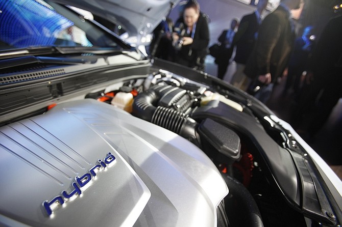FILE In this file photo taken Wednesday, March 31, 2010, the engine inside the 2011 Hyundai Sonata Hybrid is displayed at the New York International Auto Show in New York. The Obama administration is setting tough gas mileage standards for new cars and trucks, spurring the next generation of fuel-sipping gas-electric hybrids, efficient engines and electric cars.(AP Photo/Seth Wenig, file)