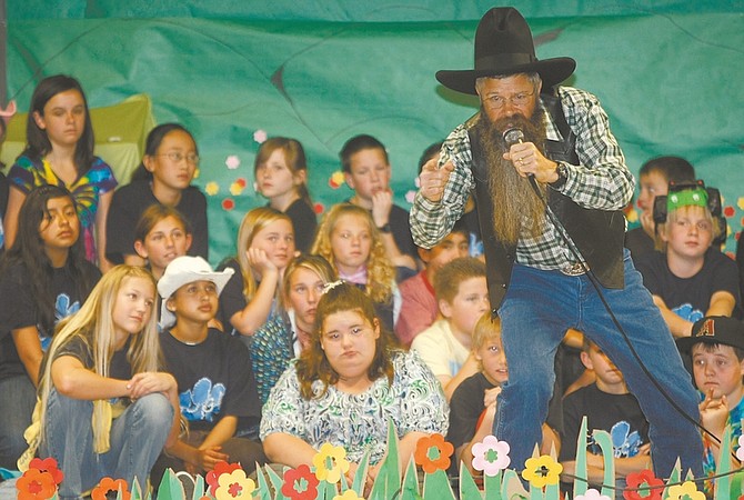 Shannon Litz/Nevada Appeal News ServiceCowboy poet Tony Argento performs Friday at Gardnerville Elementary School. Argento is a headliner at the Genoa Cowboy Poetry and Music Festival, which starts today.