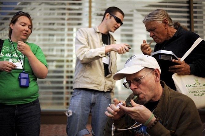 ** HOLD FOR RELEASE UNTIL 12:01 A.M. EDT TUESDAY, APRIL 20. THIS PHOTO MAY NOT BE PUBLISHED, BROADCAST OR POSTED ONLINE BEFORE 12:01 A.M. EDT TUESDAY ** FILE - In this Friday Sept. 25, 2009 file photo, attendees at the National Organization for the Reform of Marijuana Laws (NORML) conference, smoke marijuana in San Francisco. (AP Photo/Russel A. Daniels, File)