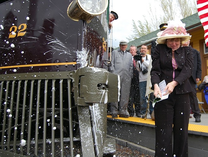 Brian Duggan/Nevada AppealRobin Reedy, chief of staff to Gov. Jim Gibbons, christens the McKeen Motor Car Sunday afternoon, marking its first voyage in more than a half a century.