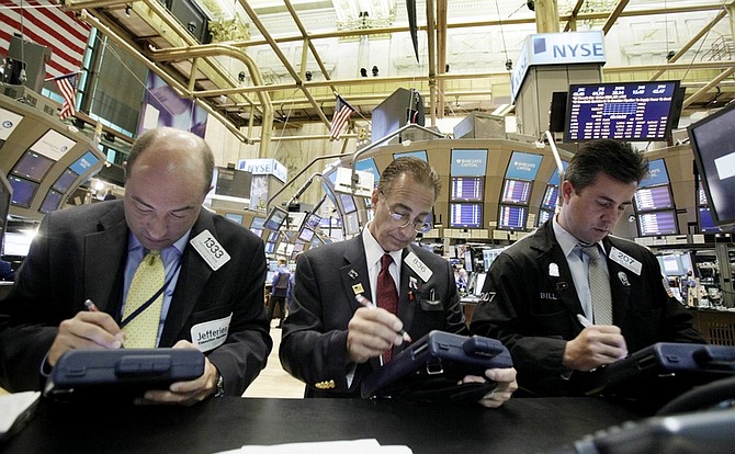 In this photo taken Wednesday, May 5, 2010, traders Christopher Morie, left, Vito Perri, center, and William Sachs work on the floor of the New York Stock Exchange. Mixed news on the U.S. labor market and retail sales weren&#039;t enough to lift stock prices Thursday, May 6, as worries lingered that Greece&#039;s debt woes would spread to other parts of Europe.(AP Photo/Richard Drew)