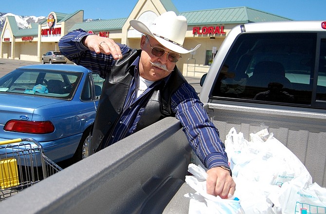 Brian Duggan/Nevada AppealTerry Potter, a retiree in Carson City, loads groceries into the bed of his truck Monday after shopping at Sak N&#039; Save. The grocery store will close May 30.