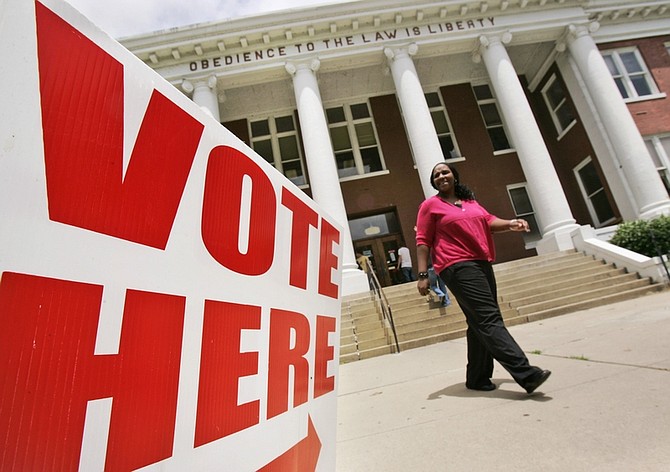 County employee Shericka Montgomery walks from the Crittenden County Court House in Marion, Ark., Monday, May 17, 2010. The building is one of the polling places in Arkansas&#039; May 18 party primary elections. (AP Photo/Danny Johnston)