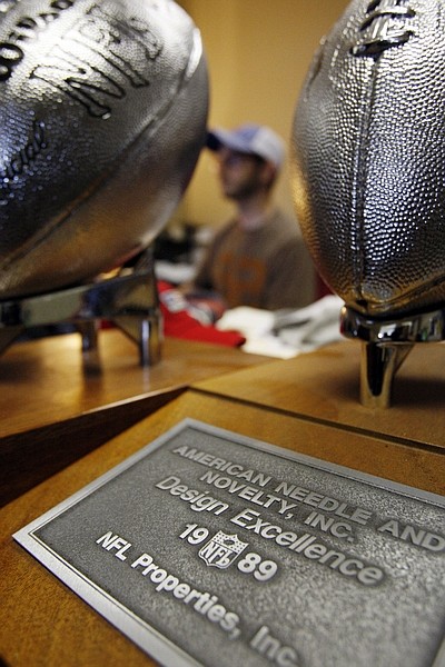 FILE - In this June 29, 2009 file photo, American Needle&#039;s Dan Parenti works on the computer at his office in Buffalo Grove, Ill.  The Supreme Court on Monday turned away the National Football League&#039;s request for broad antitrust law protection, ruling that the league can be considered 32 separate teams , not one big business , when it comes to selling branded items like jerseys and caps. (AP Photo/Nam Y. Huh, File)