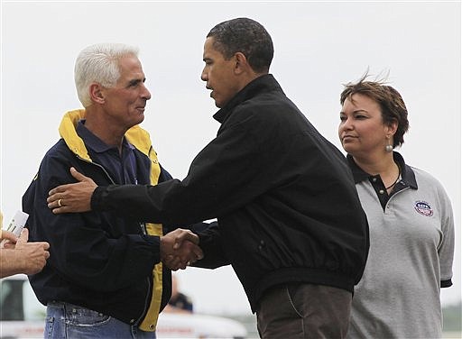 President Barack Obama is greeted by Florida Gov. Charlie Crist, as EPA Administrator Lisa Jackson looks on at right, as he arrives at Louis Armstrong International New Orleans Airport, in Kenner, La., Friday, June 4, 2010. (AP Photo/Charles Dharapak)