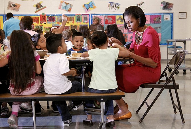 First lady Michelle Obama sits down to eat with students during a visit to New Hampshire Elementary School, with Mexican first lady Margarita Zavala, not shown, Wednesday, May 19, 2010, in Silver Spring, Md. The school, which was awarded the USDA&#039;s  Healthier US School Challenge Silver Award in 2009, serves more than 400 Pre-K, Head Start, first and second grade students, many who come from Central America, South America, and other countries. (AP Photo/Pablo Martinez Monsivais)