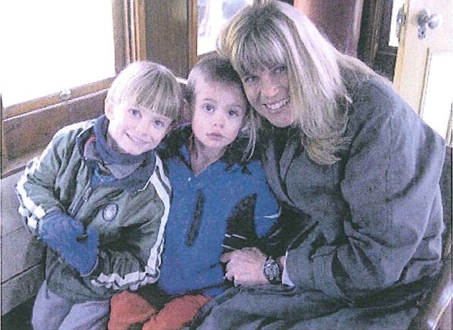 Kim Brune, 43, shown here with her sons Nicholas and Kyle, was located in Vacaville, Calif. this afternoon, some five hours after she allegedly fled with the boys from their TImberline home.