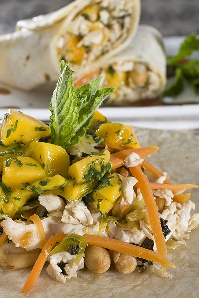 Thai-style chicken wraps with mango salsa are seen in this May 16, 2010 photo. Easy to eat while maintaining a level of sophistication these wraps are great for a dinner alfresco.   (AP Photo/Larry Crowe)