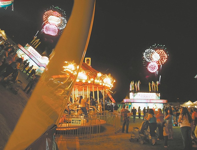 Published Caption: Fireworks light up the sky over the RSVP carnival Saturday at Mills Park during its annual Fourth of July celebration.