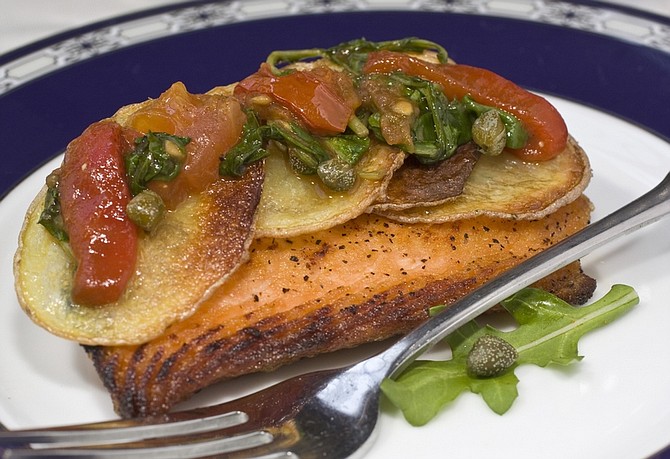 This photo taken Feb. 4, 2010 shows potato-crusted salmon with tomato and arugula relish which has the king of fish topped with a tangy relish that is colorful as well as delicious. (AP Photo/Larry Crowe)