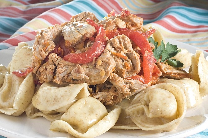 Pulled pork with roasted red peppers, sun-dried tomatoes and tortellini is seen in this June 14, 2010 photo. Forego the bun and mate your next pulled pork with pasta with this recipei. (AP Photo/Larry Crowe)