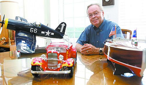 Shannon Litz/Nevada AppealDan Stockwell with three of the more than 300 models he has built. Pictured are a F4U Corsair, a 1932 Ford Roadster with a Pontiac engine and a 1940 Barrel Back Chris Craft.