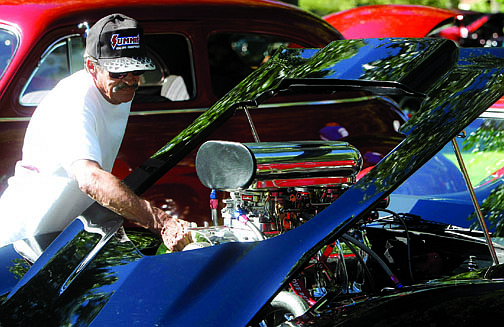 Shannon Litz/Nevada AppealCarson City resident Leo Martin cleans up his 1979 Corvette that was on display at Mills Park on Saturday for the show and shine.