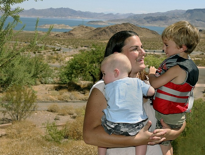 Jennifer Torrance holds her sons, Nathan, 6-months, left; and Tommy, 5, on Aug. 4, 2010, as she talks about their experience after their boat sank in Lake Mohave last Saturday. Twelve members of the family, including seven children, survived when their 24-foot boat sank. (AP Photo/Las Vegas Review-Journal, John Gurzinski)