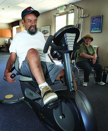 Jim Grant/Nevada AppealAs his wife Linda Gallardo looks on, Dayton resident Raul Gallardo, who suffered a stroke in May, pedals a recumbent bike during a physical therapy session at High Desert Therapists in Dayton on Friday morning.