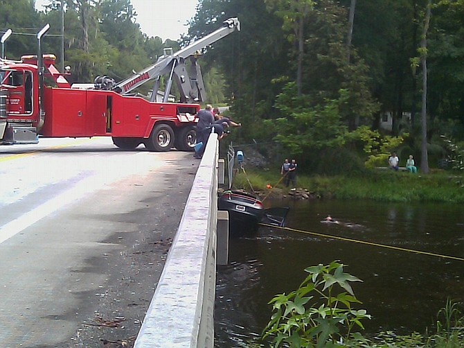 A car is lifted out of a Edisto River in Orangeburg, S.C. Monday, Aug 16, 2010. The bodies of two toddlers were recovered Monday from the car submerged in the river and their mother was charged with leaving the scene as authorities investigated whether it was an accident. Orangeburg County Sheriff Larry Williams said the boys, ages 1 and 2, were recovered from the North Edisto River after the car was found near a rural boat landing. (AP Photo/The Times and Democrat/TheTandD.com , Larry Hardy) MANDATORY CREDIT