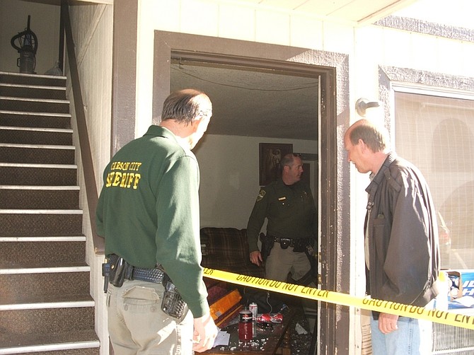 F.T. NortonSheriff Ken Furlong and Crime Scene Technician Keith Urbanski look inside an apartment on Menlo Drive where several people were arrested in connection with an early morning shooting.