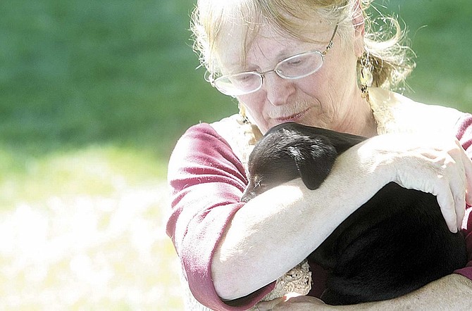 Shannon Litz/Nevada AppealLinda Stewart cuddles with a orphaned puppy Friday at Fuji Park while telling of how her dog, Topaz, was shot and killed by a Carson City Sheriff&#039;s deputy.